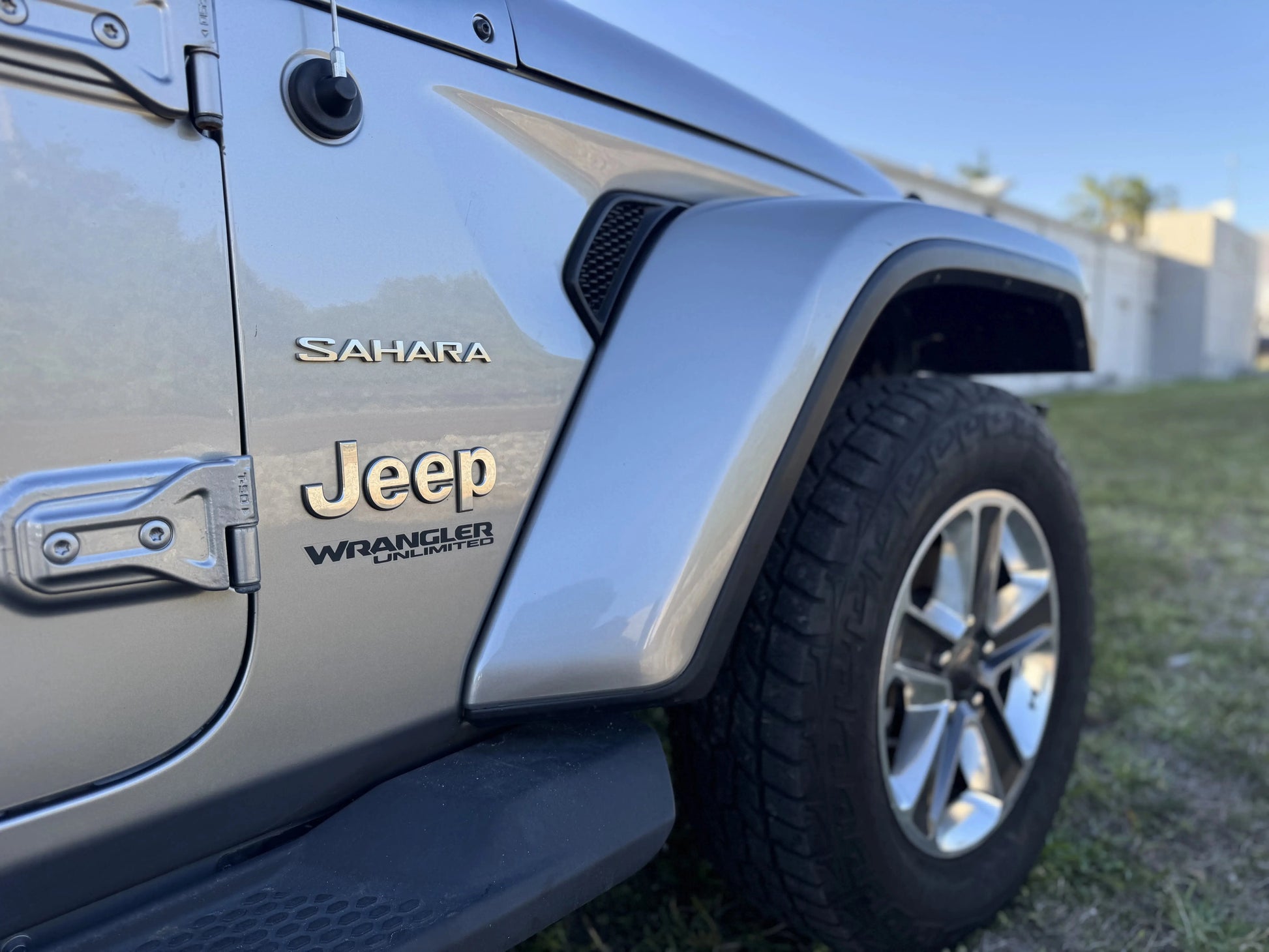 Close-up of a 2020 Jeep Wrangler Sahara showcasing the silver exterior and features, highlighting its status as a repairable & salvage car for sale.